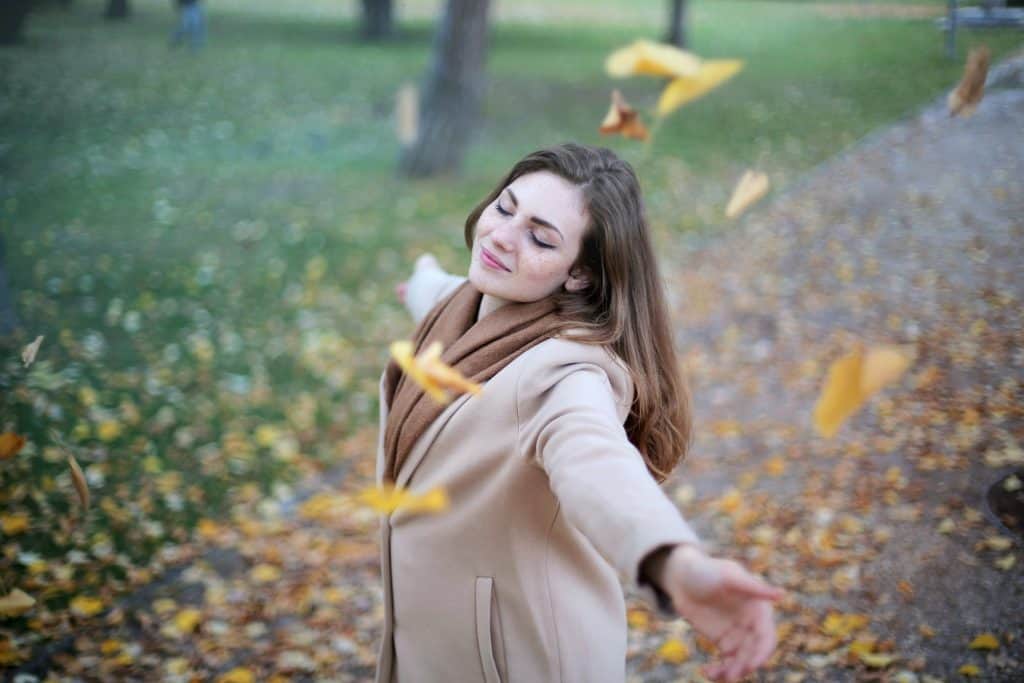 You Are Good Enough And This Is Why 4 Woman with eyes closed spinning around as leaves fall