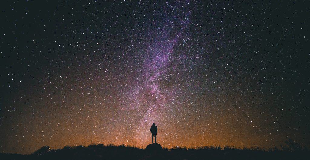 Silhouette of a person in front of a starry sky