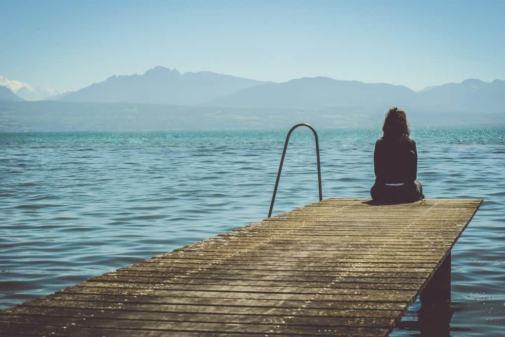 Understanding your self-image and identity 2 woman sat on the end of a pier