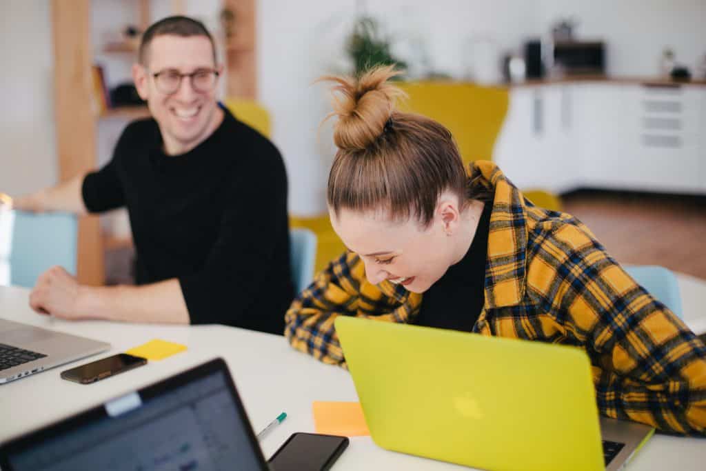 Woman and man laughing in office