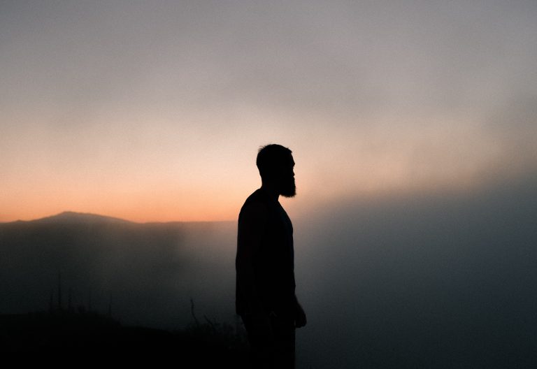 Silhouette of a man against a sunset
