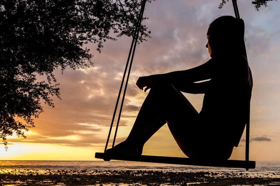 The pursuit of perfectionism is hampering your happiness (and what you can do about it) 3 person sat by the ocean considering how to deal with perfectionism