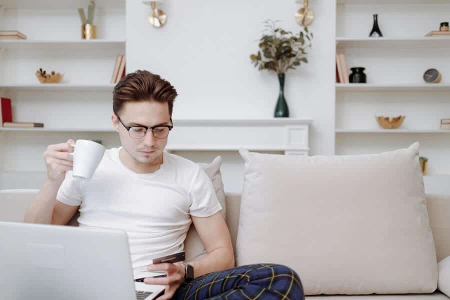 man with money addiction shopping online