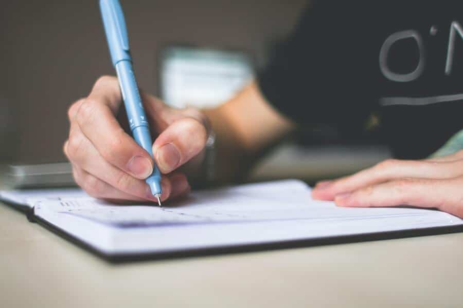 Is Money Addiction Real? How To Break Bad Spending Habits 12 person writing