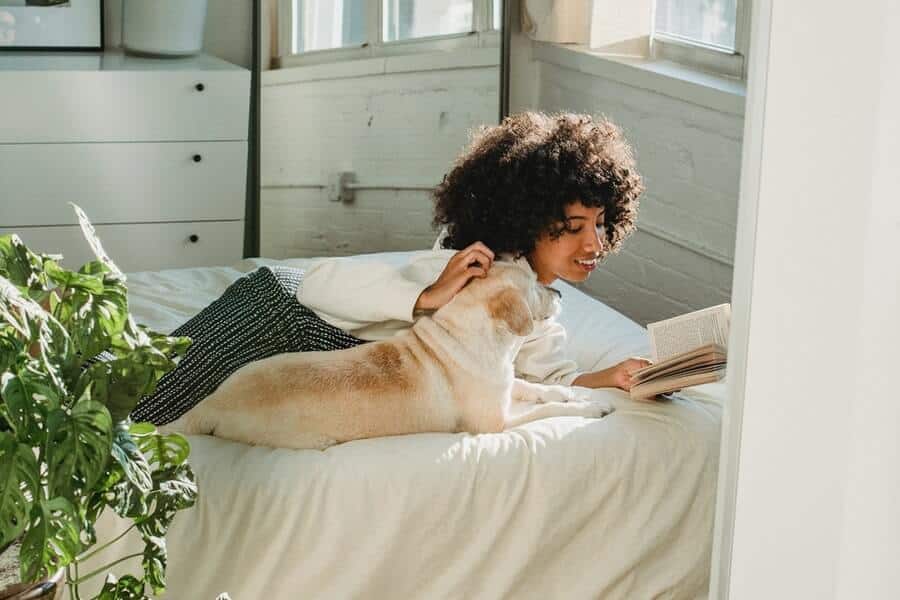 12 Ways To Beat The Sunday Blues 8 Woman relaxing with pet dog