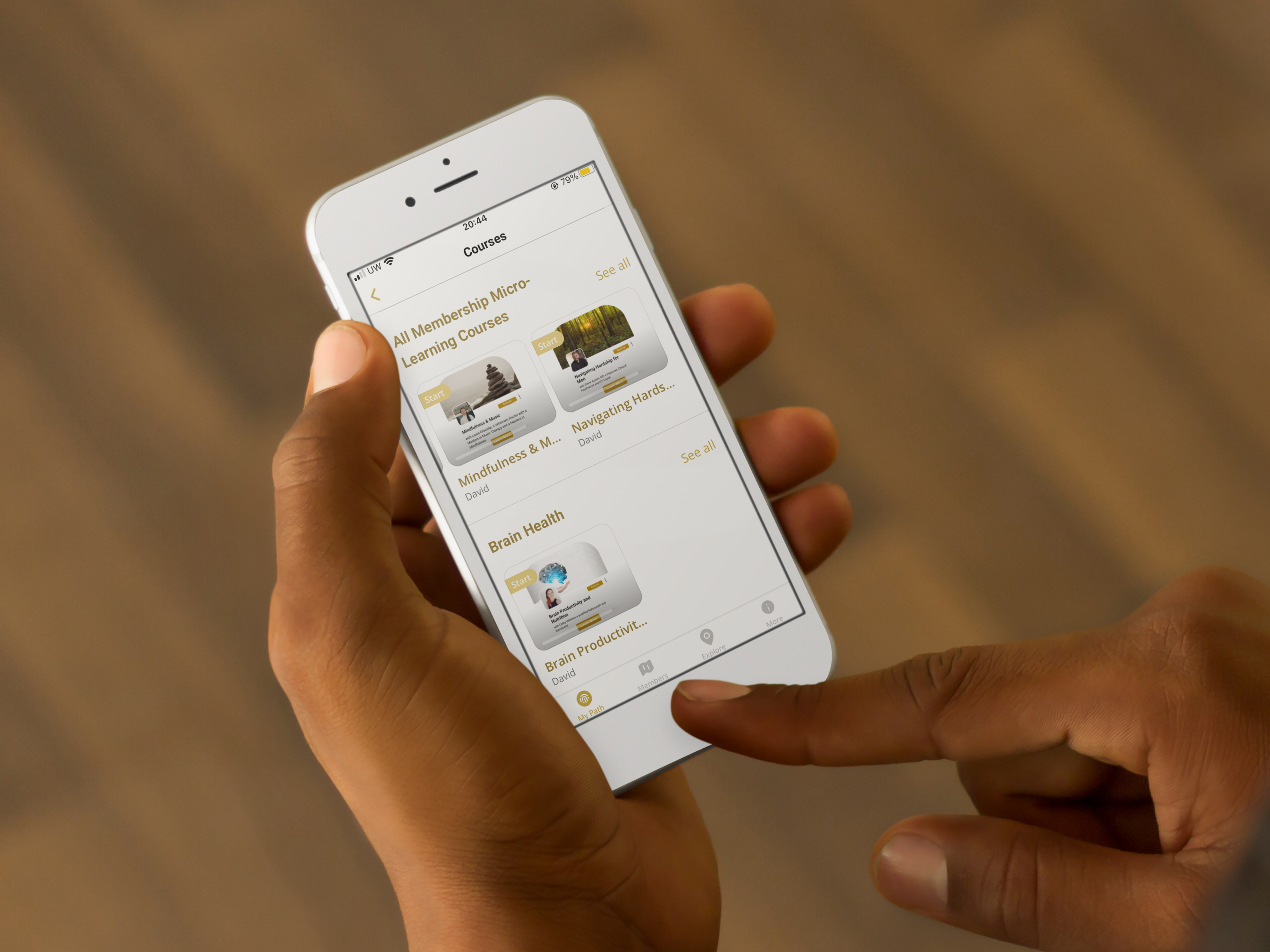 Memberships 5 man using iphone 6 over wooden floor background 1