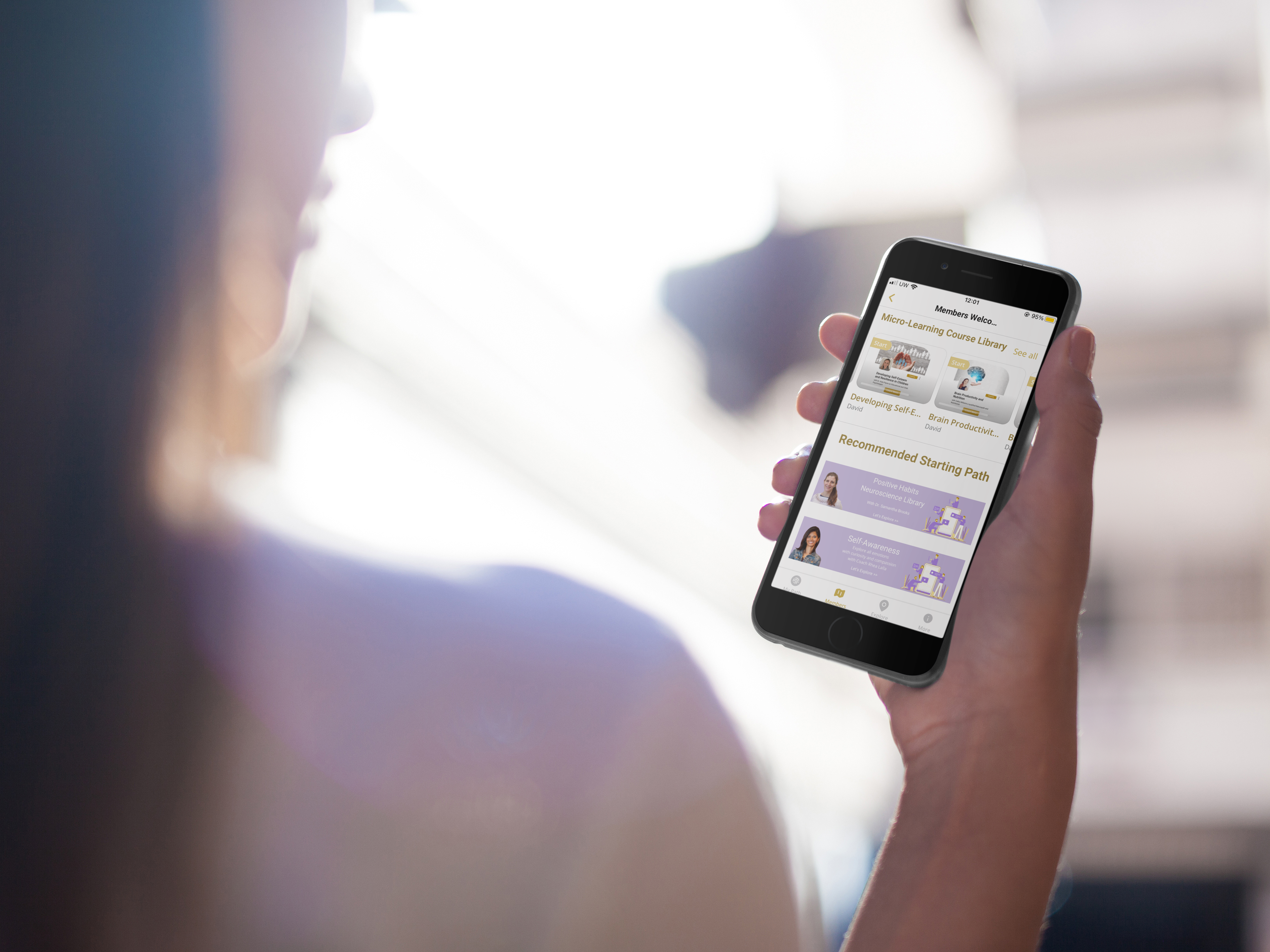 Memberships 7 over shoulder mockup of a girl holding a black iphone 6 under the sun 14033